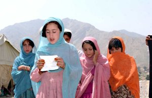 An Afghan school girl sings a prayer in celebration and for blessing during a ground breaking ceremony in the village of Dar Bhabba in the Nangahar province May 15. The school that will be built here is funded by the Jalalabad Provincial Reconstruction Team. Photo by United States Army, https://commons.wikimedia.org/wiki/File:Afghan_girls_in_Nangarhar.jpg